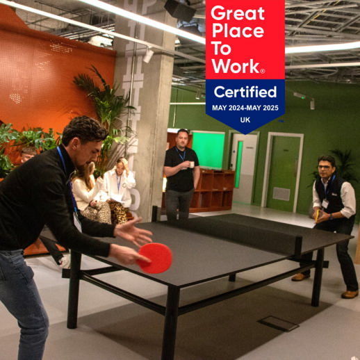 Photo of 2i team members playing table tennis