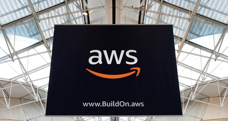 Photograph looking up at a large poster with a AWS logo in the centre